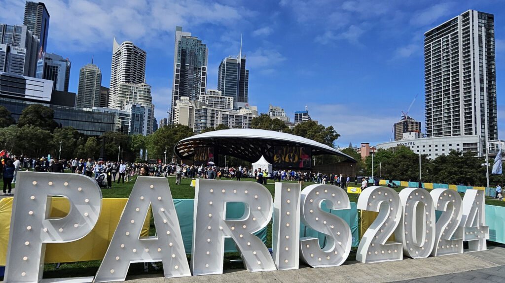 Pillingers Marquee glows over a sign that reads Paris 2024